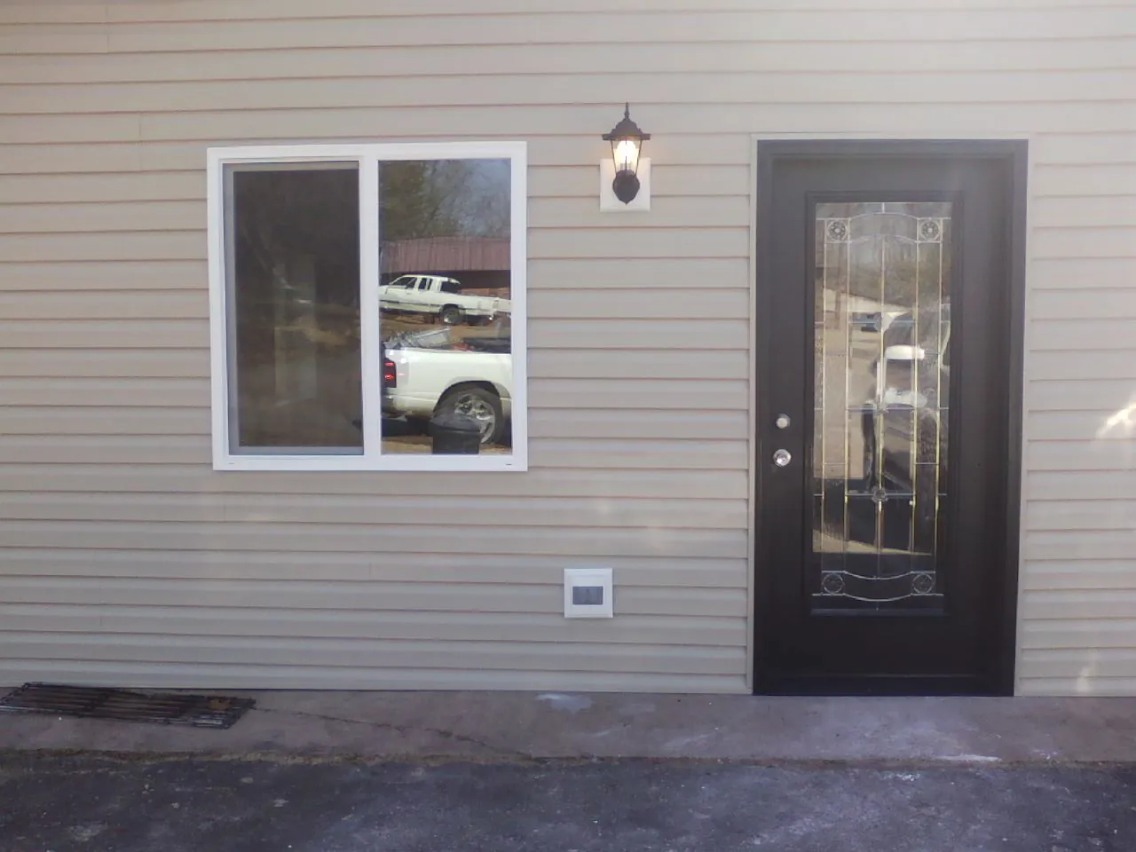 New siding, window and entry door on the side of an addition in Campo